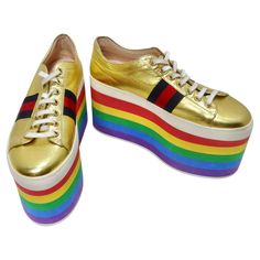 Introducing the Gold Leather Gucci Sneakers with signature navy and red stripes and a playful 3.34" rainbow platform. These sneakers are not just shoes; they're a fashion statement that's both vibrant and fun. Gucci is synonymous with luxury and style, and these sneakers embody the brand's signature look. The classic navy and red Gucci stripes on the sides make a bold and recognizable statement. The gold leather design is a symbol of opulence and elegance. It adds a touch of luxury to your look, Chanel Clutch, Gucci Shop, Versace Dress, Gucci Sneakers, Colorful Shoes, Signature Look, Platform Sneakers, Gold Leather, Leather Design