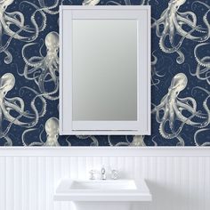 a bathroom with an octopus wallpaper and a mirror on the wall next to it