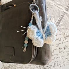 a crocheted butterfly is attached to a purse