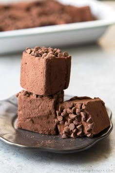 three pieces of chocolate fudge cake on a plate