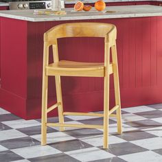 a kitchen with an island and stools in the center, along with red cabinets