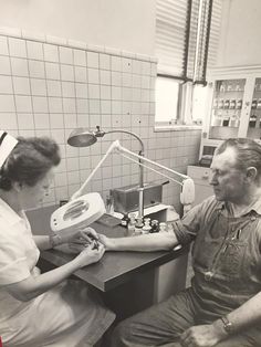 an old photo of a man and woman in a dentist's office