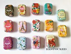 nine different types of tins with flowers and animals on them, all painted in different colors