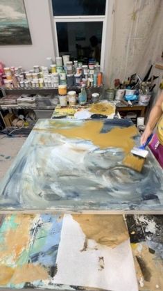 a woman is painting in an art studio