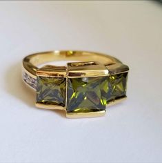 New 18k Gold Plated Princess Cut Peridot Ring For Women All Gemstones Are Simulated. A Jewelry Box Included. Ready To Ship Same Day. Feel Free To Ask Any Question. All Photos Are Real Time From Actual Object No Stock Photo Used. Color Might Be Slightly Different Due To Lighting. Luxury Gold Jewelry With Peridot, Luxury Gold Peridot Jewelry, Elegant Yellow May Birthstone Jewelry, Peridot Yellow Gold Jewelry With Center Stone, Yellow Gold Peridot Jewelry With Center Stone, Classic Gold Ring With Peridot, Peridot Center Stone Yellow Gold Jewelry, Emerald Cut Peridot Jewelry For Formal Occasions, Emerald Cut Peridot Jewelry For Formal Events