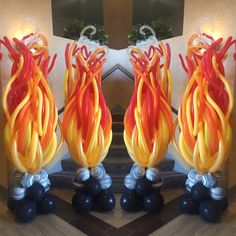 two decorative vases made out of blown glass are shown in front of a fireplace