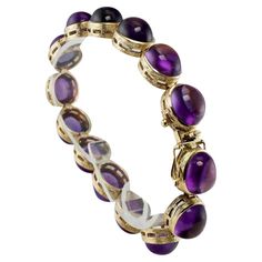 Amethyst Bracelet Cabochons 14K Gold 32.06 Tcw Vintage This gorgeous estate bracelet is finely crafted in solid 14K Yellow gold and it is set with genuine Earth mined Amethyst cabochons. Each gem is 10mmx 8mm for the total weight of 32.06 carats. These cabochons are great quality stones of good intensity. The bracelet is 7 inches long and8mm thick. Perfectly working clasp. The bracelet weighs a very substantial 31.8 grams and it is in great estate condition. *The matching Necklace is available i Luxury Vintage Purple Bracelets, Luxury Multicolor Cabochon Bracelet, Luxury Purple Cabochon Jewelry, Antique Gemstone Bracelets, Antique Round Gemstone Bracelets, Luxury Yellow Gold Amethyst Bracelets, Elegant Cabochon Bracelets For Anniversary, Formal Purple Cabochon Gemstones, Luxury Round Amethyst Bracelets