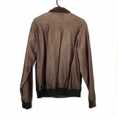 Stay stylish with this Five Four Men’s Faux Leather Bomber Jacket in size M (38-40). Featuring a sleek brown polyurethane exterior and a soft polyester lining, this jacket is perfect for casual wear. With a chest measurement of 42 inches and a length of 28 inches, it offers a comfortable fit. In Excellent Used Condition (EUC), this jacket includes ribbed cuffs and hem, giving it a classic bomber style while providing extra warmth and a snug fit. The full zip closure and side pockets add function Brown Business Outerwear With Pockets, Urban Brown Leather Jacket For Winter, Brown Casual Leather Jacket With Padded Collar, Casual Brown Leather Jacket With Padded Collar, Casual Brown Leather Jacket For Winter, Masculine Brown Outerwear With Pockets, Brown Urban Outerwear With Pockets, Brown Outerwear With Zip Fly For Work, Masculine Brown Outerwear For Work