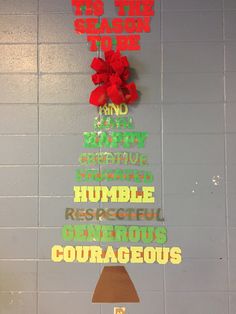 a christmas tree made out of letters and bows on a wall with the words, the one reason to be true