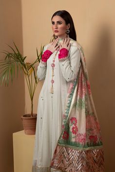 A long chiffon kalidar suit featuring similarly flared pants in shimmering golden silk. The suit features full mukesh work. Paired with a printed dupatta with with silver sequins.3-Piece SuitReady to wear Festive Tissue Silk Salwar Kameez With Naqshi, Maxi Length Salwar Kameez With Mirror Work In Chanderi, Maxi Length Chanderi Salwar Kameez With Mirror Work, Silk Palazzo Set With Dupatta In Maxi Length, Festive Georgette Sharara With Naqshi Detailing, Festive Georgette Sharara With Naqshi, Festive Sharara With Naqshi In Georgette, Festive Anarkali Set With Naqshi In Tissue Silk, Festive Tissue Silk Anarkali Set With Naqshi