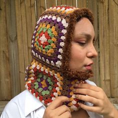 a woman wearing a crocheted hat and scarf