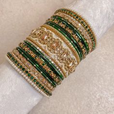 A Large stack of luxurious antique Gold bangles with vibrant green shades and stunning Champagne crystal kada bangles.  Perfect for brides or those wanting to make a statement. Ready to Ship! Antique Gold Bangles, Cristal Champagne, Bridal Survival Kit, Kada Bangles, Bangle Stack, Desi Jewelry, Bridal Jewellery Inspiration, Colorful Bangles, Hand Harness