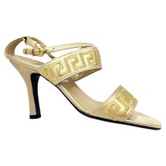 Vintage Gianni Versace gold greca heels in size 36. Feature Material: Gold-tone Leather Condition: Very good, light signs of wear as pictured. Colour: Gold Size: IT 36 Period: 1990- Place of Origin: Italy Gold Versace Dress, 1990s Shoes, Versace Gold Heels, Medusa Heels Versace, Versace Leaf Heel, Versace Vintage, Black And Gold Versace Shoes, Versace Gold, Gianni Versace