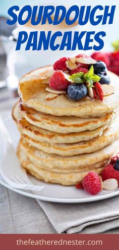 a stack of pancakes with berries and blueberries on top