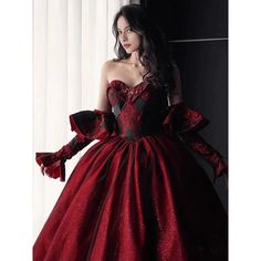 This Gothic Black And Red Wedding Dress With Gloves is sure to make a statement on your special day. Featuring a classic Burgundy Ball Gown silhouette, this dress is crafted from fine, luxurious fabrics and adorned with intricate embroidery. The sweeping skirt is adorned with delicate lace embroidery, while the bodice is tailored with a corset-style top and adjustable ribbon straps. The long, elegant gloves of this dress add a touch of sophistication, while the deep red and black colors lend a Red Ball Gown For Banquet, Fitted Red Ball Gown For Debutante Ball, Red Ball Gown Wedding Dress For Banquet, Floor-length Burgundy Ball Gown For Wedding, Burgundy Floor-length Ball Gown For Wedding, Red Evening Wedding Dress For Prom Season, Red Wedding Dress For Prom Season Evening, Burgundy Evening Dress For Wedding, Burgundy Ball Gown Evening Dress