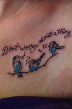 a woman's chest with two birds on it and the words don't worry about