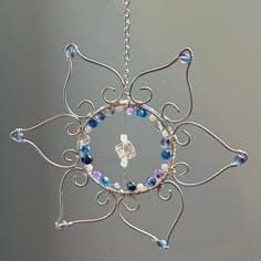 an ornament made out of wire and glass beads