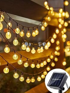 solar powered fairy lights are hanging from the side of a window