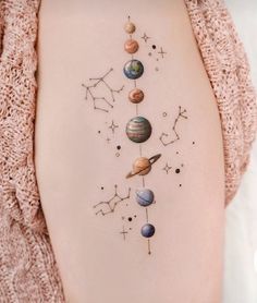 a woman's stomach with planets and stars on it