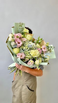 a man holding a bouquet of flowers in his hands