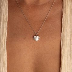 Our Mother of Pearl Heart Locket combines both sentimentality and elegance. Insert any picture that is close to your heart in the dainty locket charm and allow that image to bring you peace whenever you need it. The delicate chain and pendant are perfect for layering with your other meaningful pieces to create a nostalgic jewelry look. SKU: RR-NR171 Product Details Material: High Quality Solid 925 Sterling Silver Finish: Sterling Silver ∙ 18K Gold Locket comes without a photo. Photo insertion se Couples Lockets Necklaces, Nostalgic Jewelry, Dainty Locket, Pearl Locket, Dainty Silver Necklace, Initial Tag Necklace, Silver Heart Locket, Sterling Silver Locket Necklace, Sideways Initial Necklace