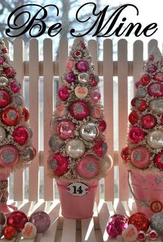 pink and silver ornaments are arranged in buckets