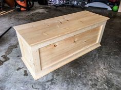 a wooden box sitting on the ground in a garage