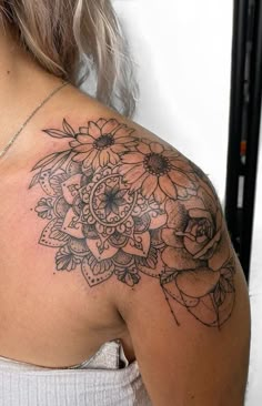 a woman with a tattoo on her shoulder