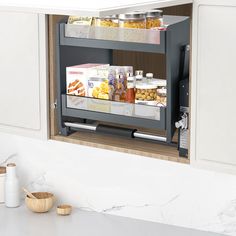 an open cabinet in a kitchen with food items on the counter top and below it