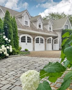 a white hydrant sitting in front of a large house