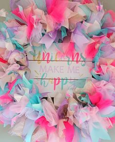 a pink, blue and green wreath with words on it