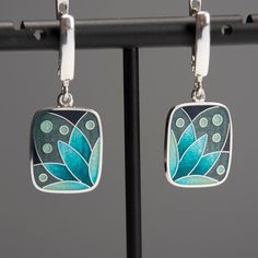 "Weight - 7 gr (approx) Length - 34 mm/1.33\" (including ear wire) Width - 15 mm/0.59\" Materials - Sterling Silver, Fine Silver, Cloisonne Enamel. Rectangle earrings with turquoise flower. Small and light earrings perfect fits for everyday wearing. The base underneath the enamel layer is engraved which gives my pieces even more loveliness and charm. Latch back ear wires has a safe lock and also made from Sterling Silver. Earrings covered with hot transparent enamel. Enamelling is an art of deco Enamel Drop Earrings For Gifts, Enamel Drop Earrings As A Gift, Elegant Turquoise Enamel Earrings, Enamel Jewelry For Pierced Ears As A Gift, Nickel Free Enamel Dangle Earrings, Nickel-free Enamel Drop Earrings, Pierced Enamel Drop Earrings, Green Enamel Jewelry With Black Enamel, Enamel Dangle Jewelry With Matching Earrings