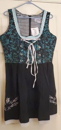 This high-quality German Dirndl women's dress is perfect for any Oktoberfest party or waitressing job. The dress is made of a comfortable cotton blend material with embroidery detailing in green and white. The size is S 44. The dress is not a costume and is made with a cotton crop top. It has embroidery backing to protect from unraveling. The dress is 65% cotton and 35% polyester. This unit type is a dress and the material is a cotton blend. The dress is made in Pakistan and comes in black, green, and white colors. Shoulder to hem 36.5"~ Pit to pit 20.5 (41") ~ Waist 17" (34") Dress Only No Apron No Blouse Embroidery Backing, Oktoberfest Party, Embroidery Detailing, Cotton Crop Top, Embroidery Details, Dress Clothes For Women, Green And White, Black Green, Apron