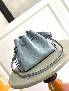 Light blue BELLA handbag Bella bucket bag is made of Monogram perforated calfskin to create a small shape, and then make the same pattern live in a round coin purse in a pocket scale, full of modern style. Braided metal and leather handles and a detachable leather shoulder strap allow for versatile carrying options. Dimensions: 19 x 22 x 14 cm Luxury Blue Bucket Bag For Daily Use, Luxury Blue Shoulder Bucket Bag, Luxury Blue Bucket Bag, Luxury Blue Pouch Bucket Bag, Blue Luxury Pouch Bucket Bag, Luxury Blue Bucket Bag For Shopping, Designer Blue Bucket Bag For Travel, Designer Blue Bucket Bag With Dust Bag, Luxury Blue Bucket Bag For Travel