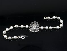 This amazing silver Rakhi crafted from 925 silver with immense precision. It exudes excellent craftsmanship and will surely look wonderful on your brother's wrist. handmade custom design God divine Bracelet Or Rakhi bracelet with silver, rudraksha and silver beaded chain, this is special design beaded bracelet we can use either Rakhi bracelet or daily use bracelet for unisex. Best Rakshabandhan Festival best wishes sibling gift for your brother and sister's , Metal-925 sterling silver. Item type Spiritual Sterling Silver Bracelet With Oxidized Finish, Spiritual Oxidized Sterling Silver Bracelet, Silver Symbolic Rosary Bracelet As Gift, Silver Beaded Bracelets With Round Beads For Festivals, Symbolic Silver Rosary Bracelet Gift, Symbolic Silver Rosary Bracelet, Symbolic Silver Rosary Bracelet For Gifts, Symbolic Silver Bracelets For Festivals, Polished Beads Sterling Silver Bracelet