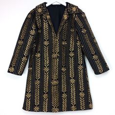 Beautiful jacket with detailed embroidery over silk. Stunning with the added luxury of black silk with golden silk thread embroidery and lightly quilted jacket is perfect to pair with your favourite jeans, flared pant or over a short dress. Best fit size small or medium, however check measurements below.  Front button down enclosure.  2 x concealed side pockets. MEASUREMENTS: Fits-Like Estimate: M Chest: 100cm (around) Waist: 92cm  Length: 80cm Arms: 56cm Shoulder: 38cm Dry Clean Only. A stand o Long Sleeve Party Outerwear With Intricate Embroidery, Festive Party Outerwear With Gold Embroidery, Festive Embellished Gold Outerwear, Festive Gold Embellished Outerwear, Formal Long Sleeve Outerwear With Gold Embroidery, Elegant Fall Outerwear With Gold Embroidery, Festive Embroidered Outerwear For Party, Elegant Gold Embroidered Outerwear, Festive Embroidered Party Outerwear