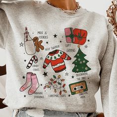 Step Into The Season Of Joy With Our 'Christmas Traditions Illustrated Sweatshirt'. Boasting Vibrant Hand-Drawn Illustrations That Capture The Essence Of The Holidays, From The Warmth Of 'Milk & Cookies' To The Fun Of 'Ugly Sweaters'. This Cozy Pullover Comes In A Variety Of Colors And Sizes, Available Exclusively On Our Website. Lovingly Crafted By Our Small Business, It's More Than A Sweatshirtit's The Spirit Of Christmas Wrapped In Comfort. Christmas Graphic Tees, Illustration Tshirt, Woven Sweater, The Spirit Of Christmas, Christmas Graphic, Winter Shirts, Star Sweater, Ugly Christmas Sweaters, Spirit Of Christmas