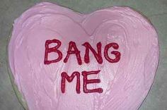 a pink heart shaped cake with the words bang me written on it