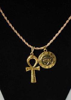 "Eye Of Horus Shield &  Large Ankh Charm Duo Necklace  ☆   Round Eye of Horus Shield Charm       is lightweight and        hollow on the back.  ☆ Charms are Made of zinc alloy with       18 Karat gold plating   ☆ Includes {1} 2mm gold ROPE chain       of YOUR CHOICE length       long with lobster clasp.       CHOOSE YOUR ROPE CHAIN LENGTH  from our pull-down menu above: ---     2mm wide by 45 cm/ 17.7 inches long      OR ---     2mm wide by 50 cm 20 inches long     OR ---     2mm wide by 55 cm 21.6 inches long     OR ---     2mm wide by 60 cm 23.6 inches long ☆ Artisan Crafted African Charm Necklace       For Her | For Him | Unisex Jewelry ☆ The Eye of Horus is an       ancient Egyptian symbol       of protection, royal power,       and good health.  ☆ The Ankh is a powerful       symbol o Cheap Spiritual Ankh Jewelry, Ancient Egyptian Jewelry Ancient Aura Jewelry, Cheap Ankh Spiritual Jewelry, Luxury Spiritual Jewelry With Crucifix Shape, Anhk Necklace Gold, Cheap Ankh-shaped Spiritual Jewelry, Cheap Ankh Shaped Spiritual Jewelry, Egyptian Jewelry Ancient Aura Jewelry, Luxury Ankh Necklace As Gift