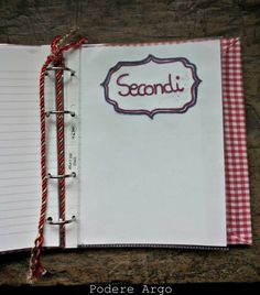 an open notebook with the word sedoni written in red and white checkered paper