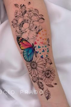 a colorful butterfly and flowers tattoo on the arm