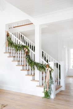 the stairs are decorated with greenery and garlands for an elegant christmas display on instagram