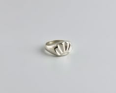 "Sterling silver woman's ring, hand carved with a design of a scallop shell.  Look down at your hand and be reminded of the reflective waters, the sun and the shells that line the ocean floor.  Hand carved from wax using the lost wax method and then cast in solid sterling silver.  Polished to a high shine.  Can be made in sizes 5 through 9, with half sizes. Signet measures 15mm wide 11 mm tall Love it but can't buy it right now? Click on the ❤️ to your right that says \"Add item to favorites.\" Gem Signet Ring, Wax Carving Ring, Lost Wax Casting Rings, Wax Carved Ring, Wax Carving Jewelry, Seashell Ring, Hand Carved Ring, Art Clay Silver, Wax Ring