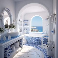 a white and blue bathroom with an arched window