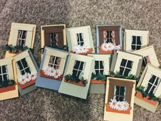 a bunch of cards that are sitting on the ground with some flowers in front of them