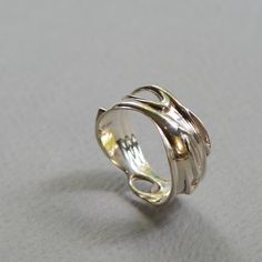 Silver frames stunning opal in this bold and elegant piece. This ring captures the liquidity of forms, as one shape flows into another. An excellent gift for the winter holidays, with its cool, mesmerizing colors. Pair with our Silver and Opal Earrings for the perfect set! Available separately: https://www.etsy.com/il-en/listing/654061483/opal-swirl-earrings-silver-and-opal?ref=shop_home_active_1 -- To see more items from RethinkGold, please visit us at https://www.etsy.com/il-en/shop/RethinkGol Elegant Artistic Jewelry For Anniversary, Elegant Artistic Design Jewelry For Anniversary, Luxury Polished Opal Ring For Gift, Elegant Opal Open Ring With Polished Finish, Elegant Polished Opal Open Ring, Elegant Open Ring Jewelry With Unique Variations, Elegant Polished Opal Promise Ring, Modern Twist Jewelry Ring With Unique Design, Modern Yellow Gold Opal Ring Gift