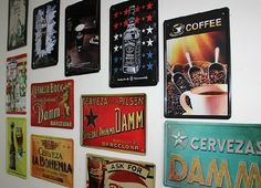 there are many signs on the wall that have been decorated with different colors and designs