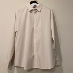 Brand New! Never Worn. It’s A Slight Off-White Color Leaning Gray / With Pink Undertones. It’s Accurately Portrayed In The Photos. The Shirt Is Definitely A Neutral / Off White And Any Color Is Just Undertones. It’s A Perfect Buttondown For Formal Occasion, Nights Out, Work, Etc. Great Material And Super Comfy! Brand: Mizzen+Main Size: Xl White Shirt With Hidden Button Closure For Spring, White Long Sleeve Shirt For Business Casual, White Business Tops With Buttons, Classic Cream Shirt With Buttons, Classic Cream Tops For Business Casual, Classic Cream Top For Business Casual, Classic Long Sleeve Plain Shirt, White Shirt With Spread Collar For Daywear, Formal Cream Shirt With Spread Collar