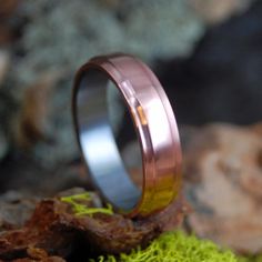 an image of a wedding ring with moss growing on it