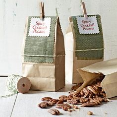 two paper bags filled with nuts on top of a table